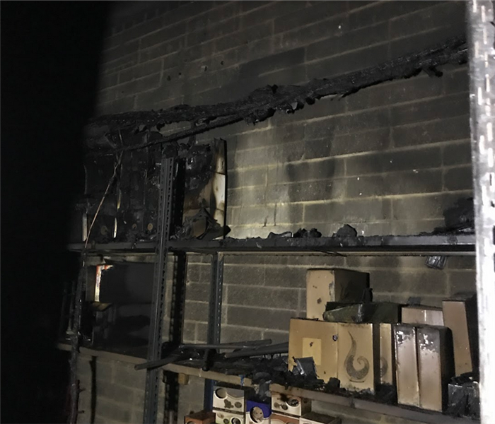 a fire damaged shelf with soot covering everything
